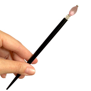 The large size of the Roxy Tidal Hair Stick made of pink cat's eye glass.