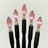 Five of the Roxy Tidal Hair Sticks made of pink cat's eye glass.