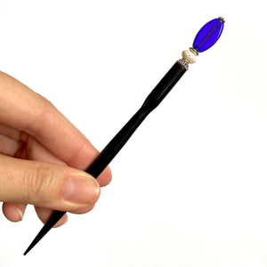 A full view of the Stella Tidal Hair Stick made from cobalt blue glass beads.