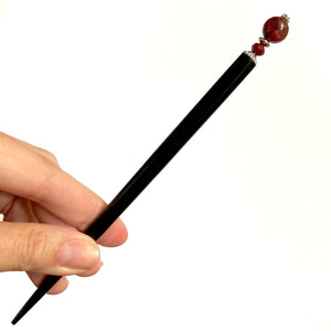 The large size of the Wynn Tidal Hair Stick made from red magenta pyrite quartz