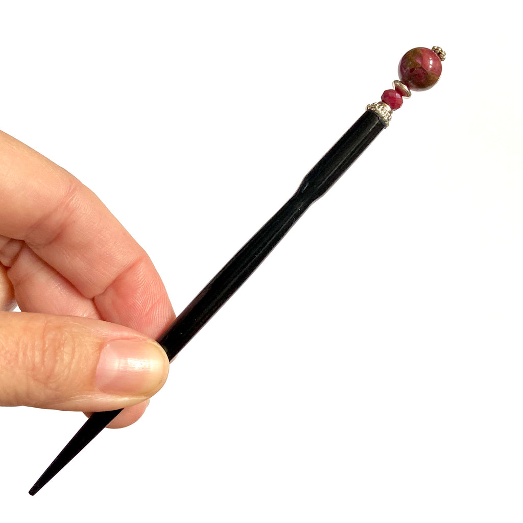 A full view of the Wynn Tidal Hair Stick made from red magenta pyrite quartz