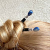 A woman wears two of our Chloe Tidal hair Sticks made from Lapis Lazuli Nuggets