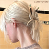Model Avery Ovard wears two Daliah Tidal Hair Sticks in her hair bun.