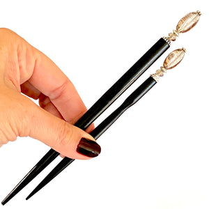 The large and standard size options for the Dharma Hair Sticks