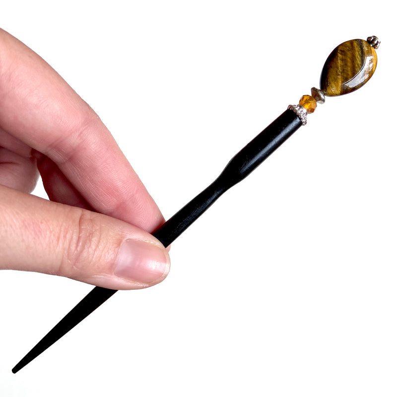 A full shot of our Nisha hair stick made from Tiger's Eye stone.