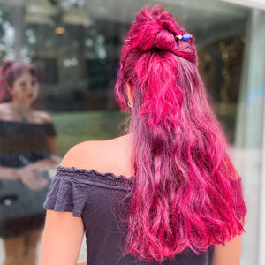 A pink-haired woman wears a Stella Tidal Hair Stick