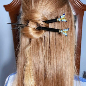 A blonde wonman wears two Mariposa Tidal Hair Sticks