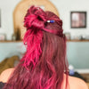 A pink-haired woman wears a Stella Tidal Hair Stick