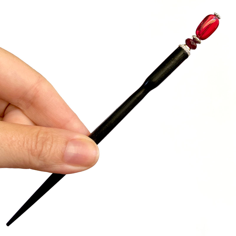 A full shot of our Madelaine Hair Stick made from bright red Czech glass beads.