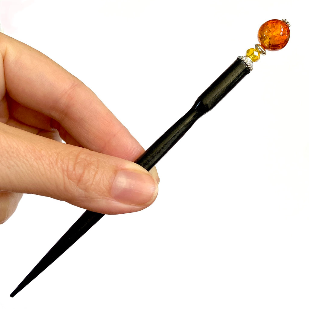 A full pic of our Maya Hair Stick made with orange-yellow crackle Czech glass beads.