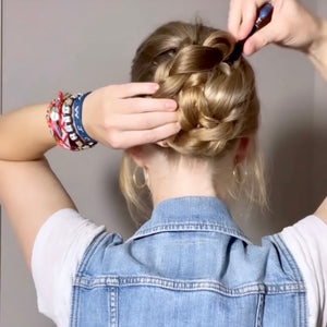 A blonde woman wears a Chloe Hair Stick in her braided hair bun