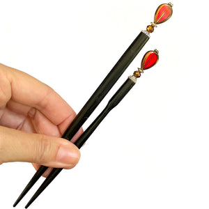 The standard and large sizes of our Reina Hair Stick made from a red Czech glass bead with bronze edging.